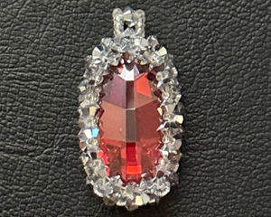 Orange oval-shaped crystal is approx. 25mm x 16mm surrounded by Swarovski Elements Crystals and seed beads. 